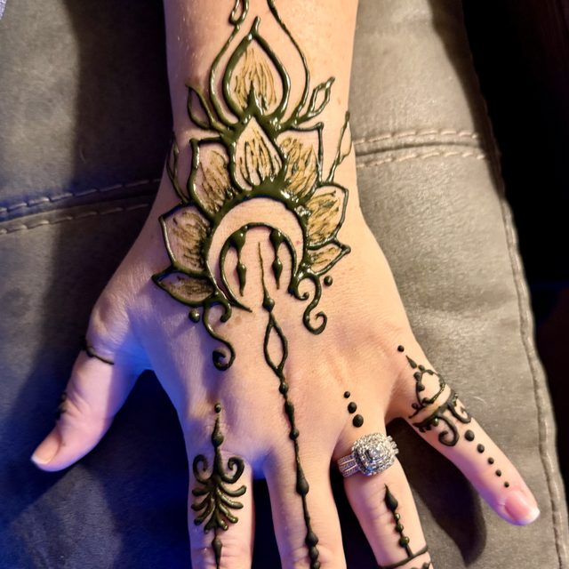 Elegant bridal henna design on the hand with rings