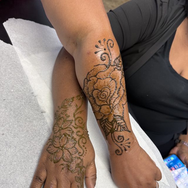 Cascading floral henna design along the arm