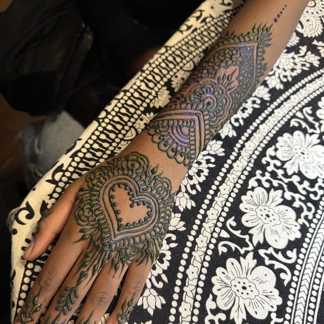 Ornate henna design with a heart motif on the hand