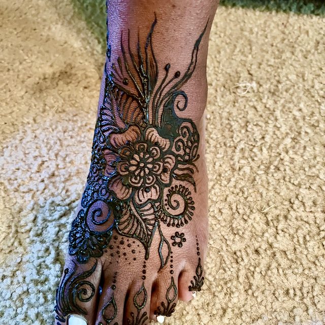 Floral henna design covering the top of the foot