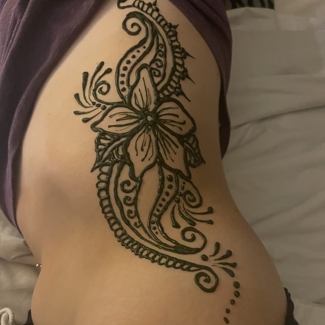 Floral henna design along the side and ribs