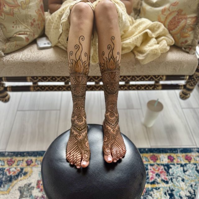 Henna designs covering both feet and lower legs
