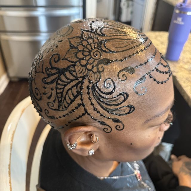 Henna crown design on the head with glitter accents