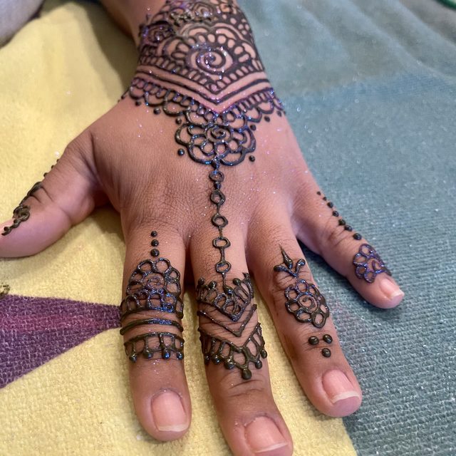 Mandala and bracelet-style henna design on the hand