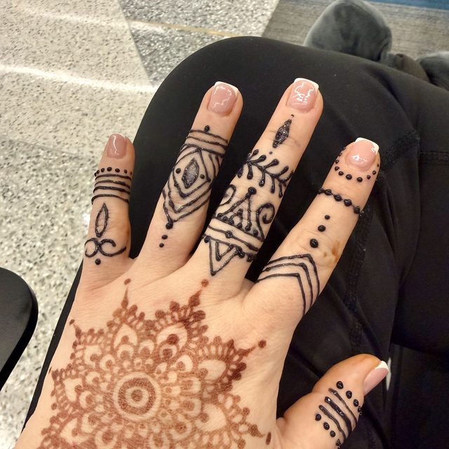 Mandala henna design on the palm with dotted fingers