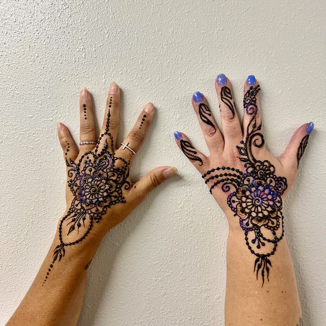 Matching henna designs on a pair of hands