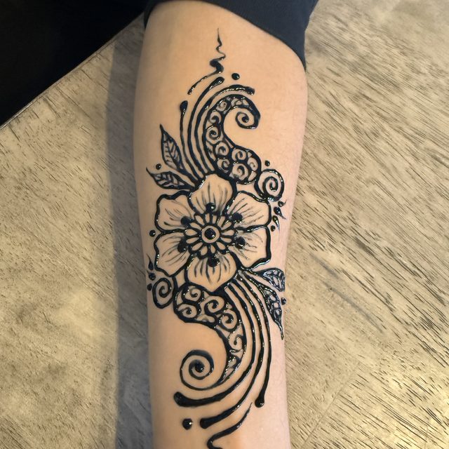 Paisley and flower henna design on the forearm