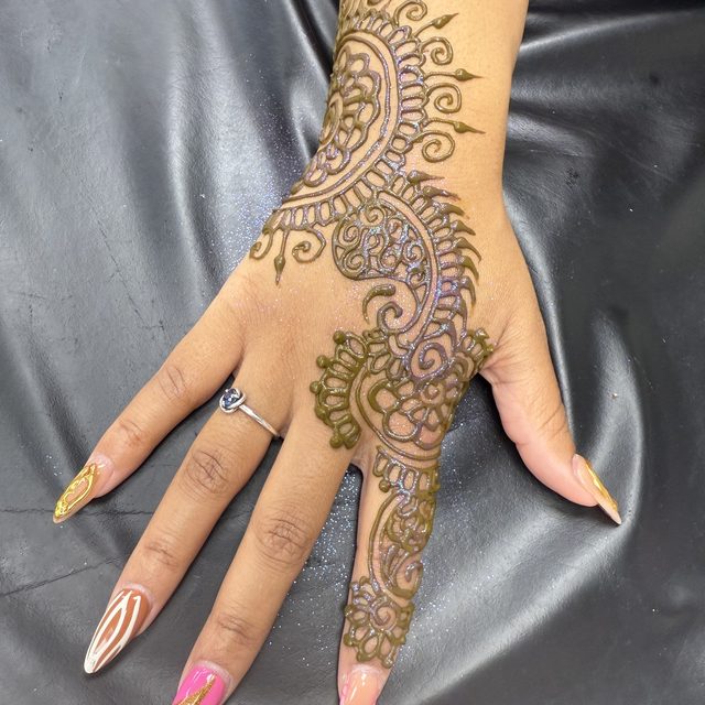 Swirling henna pattern covering the hand