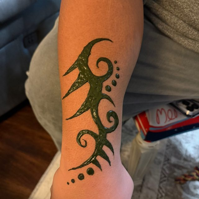 Tribal flame henna design on the ankle
