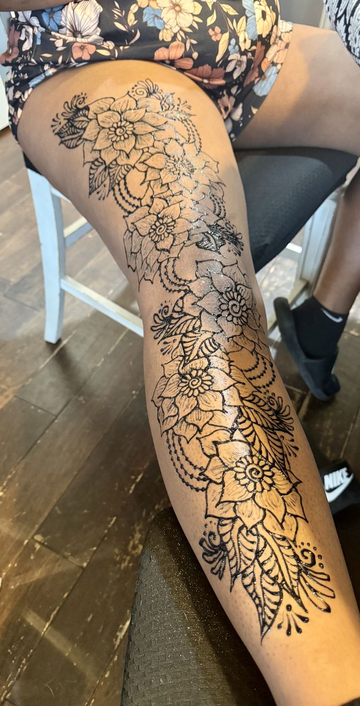 Floral henna design covering the leg by Henna House