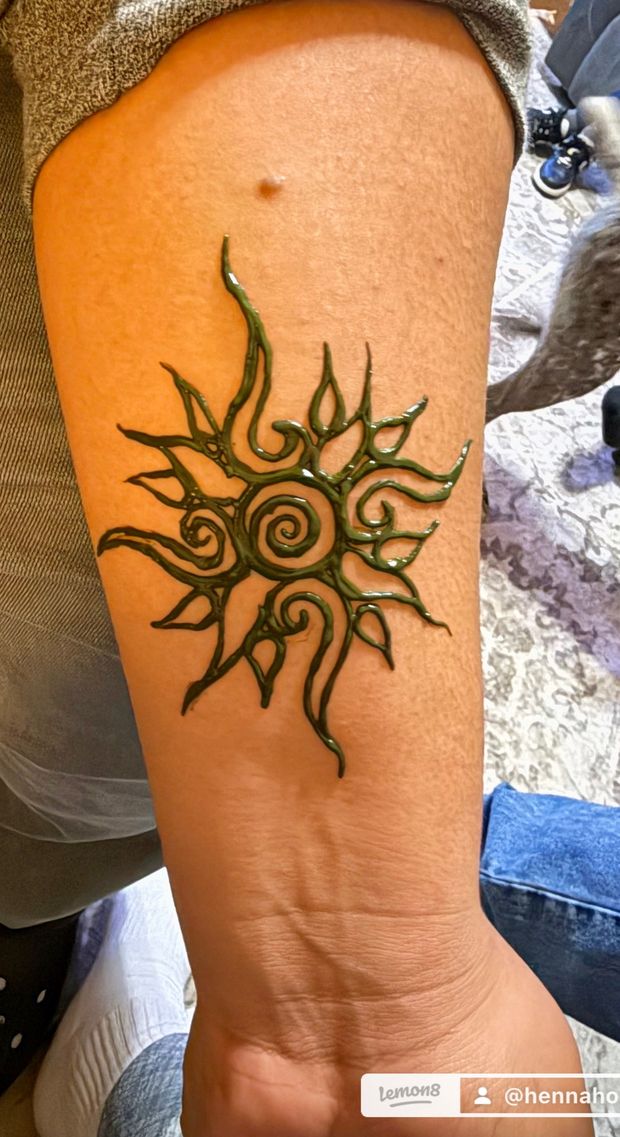 Tribal sun henna design on the arm by Henna House